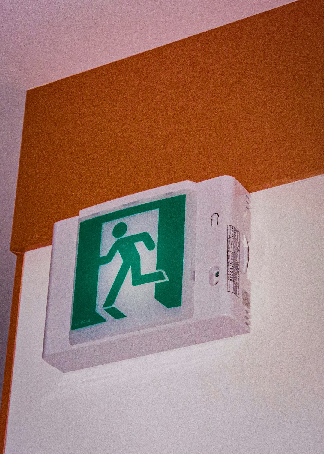 a-green-and-white-sign-on-a-white-wall-u096zvw3kri